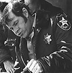 El Sheriff Leigh Brackett (Charles Cyphers)